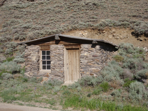 Shack that backs into a hillside.